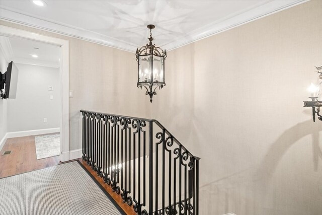 corridor featuring ornamental molding and hardwood / wood-style floors