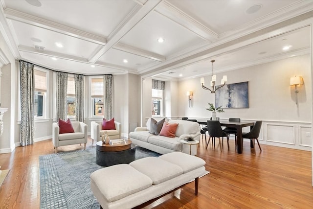 living room featuring crown molding, coffered ceiling, beamed ceiling, and light wood-type flooring