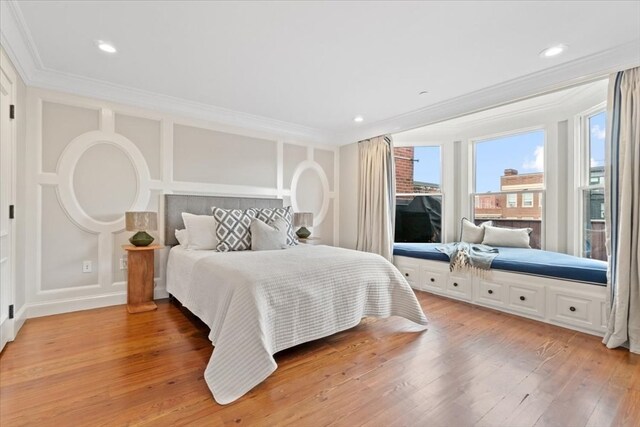 bedroom with crown molding and hardwood / wood-style flooring