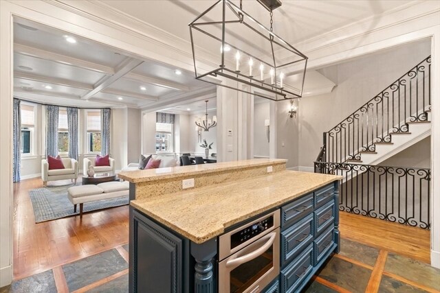 kitchen featuring a kitchen island, coffered ceiling, oven, beam ceiling, and dark hardwood / wood-style flooring