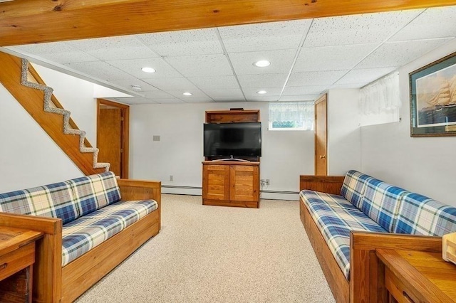 living room with a paneled ceiling, light carpet, baseboard heating, and recessed lighting