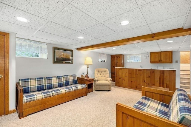 carpeted living area featuring a drop ceiling and recessed lighting