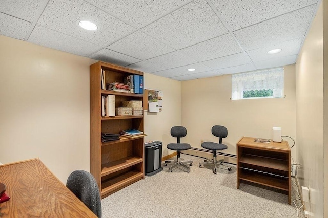 office space featuring carpet, recessed lighting, a baseboard radiator, a paneled ceiling, and baseboards