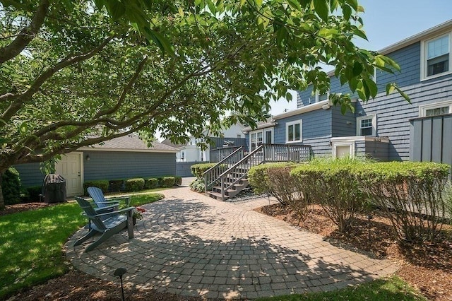 view of front of house featuring stairs, a patio area, and a wooden deck