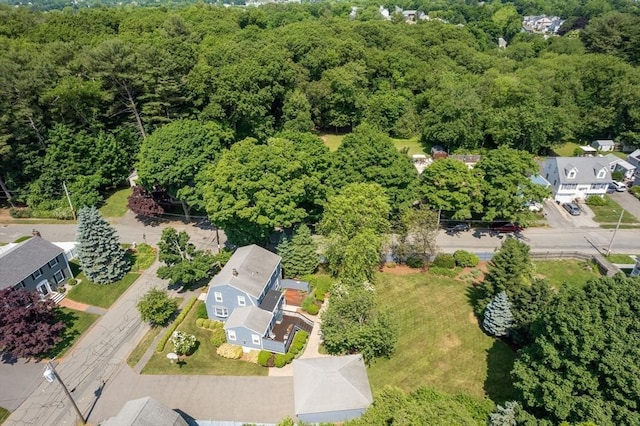 birds eye view of property with a view of trees