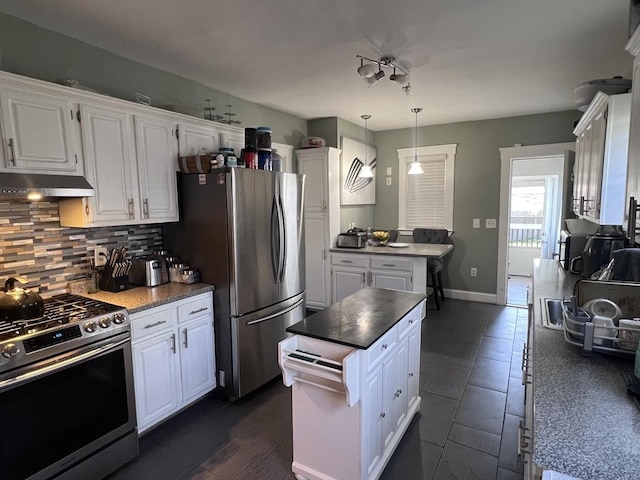 81 Rockdale St, Boston, MA 02126 - kitchen featuring stainless steel appliances, range hood, white cabinetry, decorative backsplash, and a kitchen island