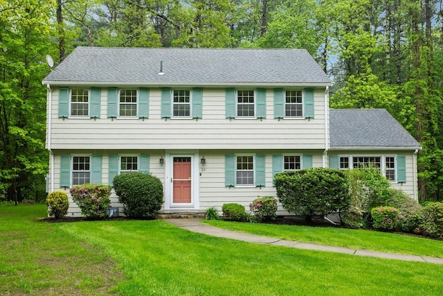 30 Juniper Cir, Concord, MA 01742 - colonial-style house with a front yard, roof with shingles, and view of scattered trees
