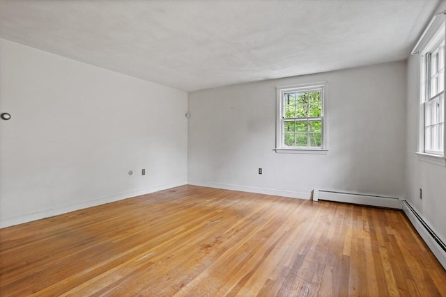 30 Juniper Cir, Concord, MA 01742 - empty room featuring light wood finished floors, baseboard heating, and baseboards