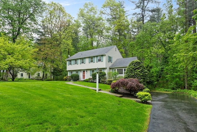 30 Juniper Cir, Concord, MA 01742 - colonial inspired home featuring a front yard and asphalt driveway