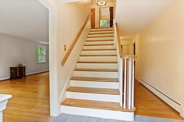 30 Juniper Cir, Concord, MA 01742 - stairs featuring a baseboard heating unit, a baseboard radiator, and wood finished floors