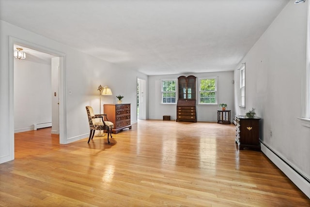 30 Juniper Cir, Concord, MA 01742 - living area featuring baseboard heating, light wood-style floors, and baseboards