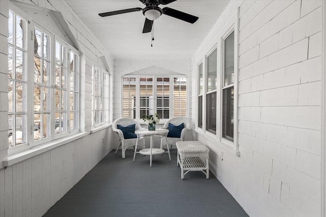 sunroom / solarium featuring ceiling fan