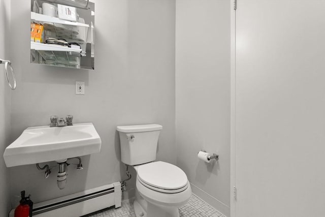 321 Harvard St Unit 302, Cambridge, MA 02139 - bathroom with baseboard heating and tile patterned floors