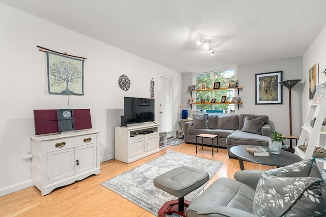 321 Harvard St Unit 302, Cambridge, MA 02139 - living area featuring light wood-type flooring and a textured ceiling