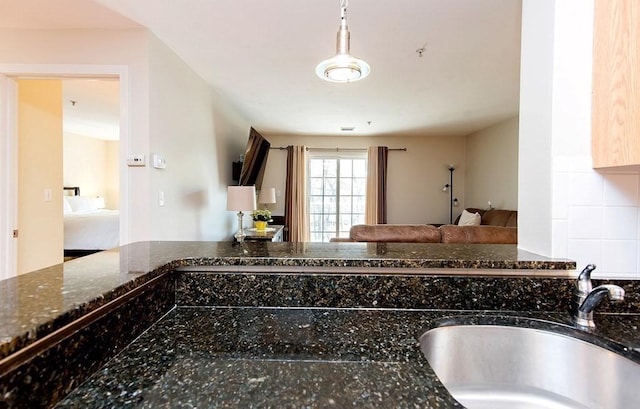 717 Washington St Unit G, Canton, MA 02021 - kitchen with a sink, dark stone countertops, and open floor plan