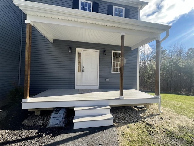 view of exterior entry with a porch