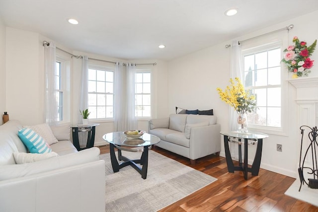 living area with baseboards, dark wood finished floors, and recessed lighting