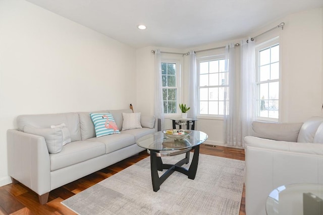 living room with dark wood finished floors and recessed lighting