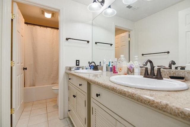 full bathroom featuring double vanity, visible vents, a sink, and tile patterned floors