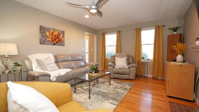 living room featuring ceiling fan and light hardwood / wood-style floors