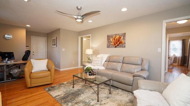 living room with ceiling fan and light wood-type flooring