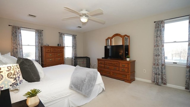 bedroom featuring light carpet and ceiling fan