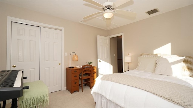 carpeted bedroom featuring ceiling fan and a closet