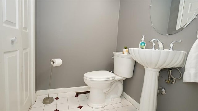 bathroom featuring tile patterned floors and toilet