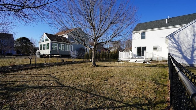 view of yard featuring a sunroom and a deck