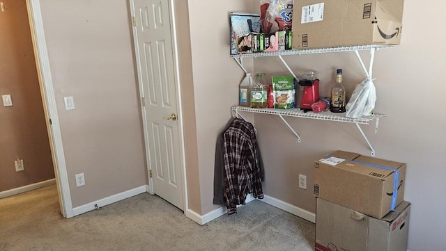 clothes washing area with carpet flooring