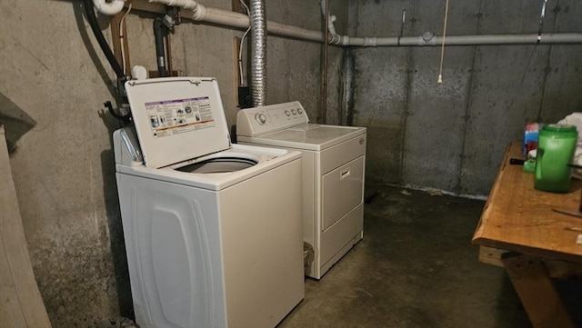 clothes washing area featuring separate washer and dryer