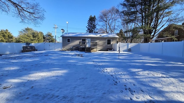 view of snow covered back of property