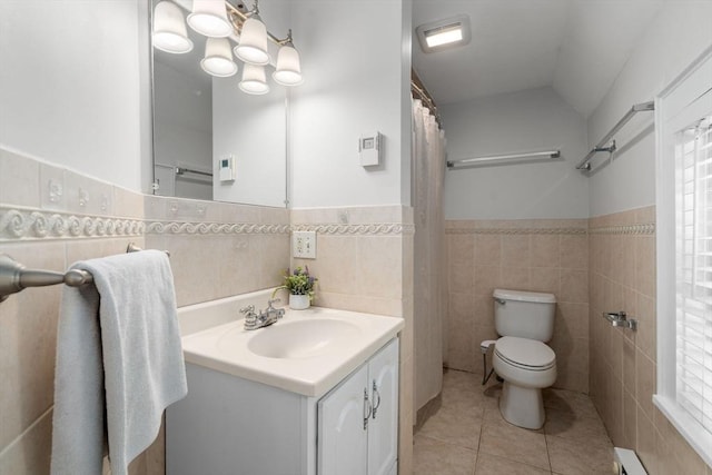 91 Freeman St, Newton, MA 02466 - full bath featuring tile walls, tile patterned floors, vanity, a baseboard radiator, and wainscoting