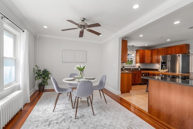 91 Freeman St, Newton, MA 02466 - dining space featuring radiator heating unit, light wood-type flooring, a ceiling fan, recessed lighting, and crown molding