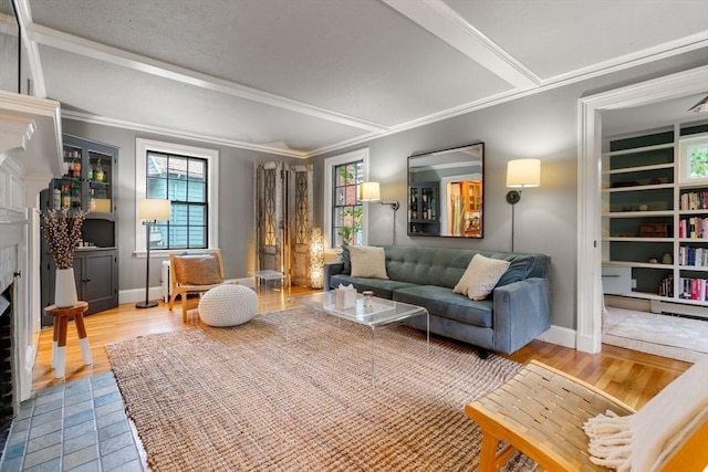 sitting room featuring baseboards, ornamental molding, and wood finished floors