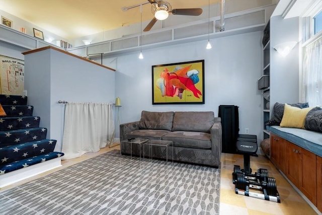 interior space featuring rail lighting and a ceiling fan