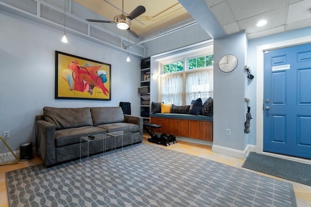 interior space with ceiling fan and baseboards