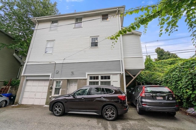 back of property featuring an attached garage