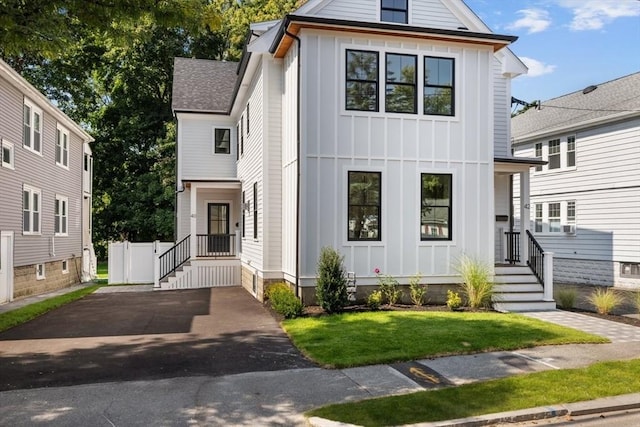 modern farmhouse style home with a front yard