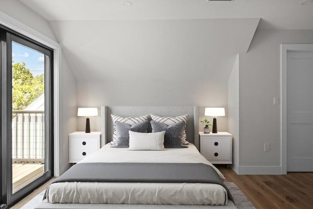 bedroom featuring lofted ceiling, dark wood-type flooring, and access to outside