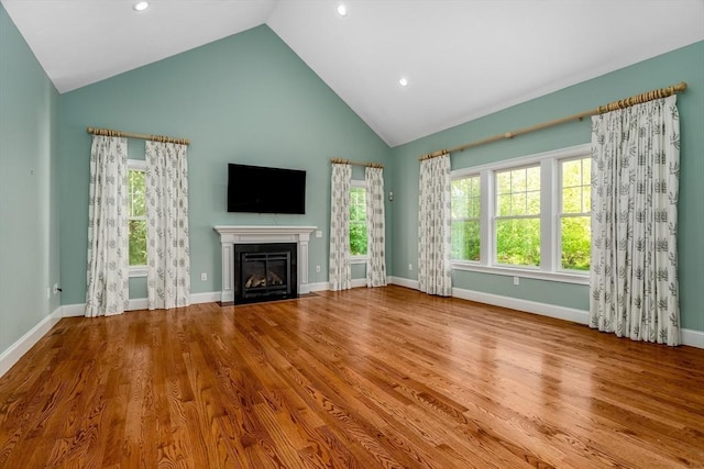 84 Bruce Rd, Concord, MA 01742 - unfurnished living room with a fireplace with flush hearth, high vaulted ceiling, recessed lighting, baseboards, and wood finished floors