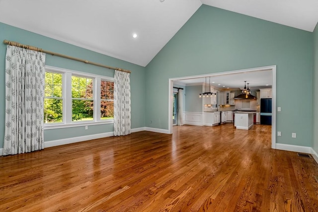 84 Bruce Rd, Concord, MA 01742 - unfurnished living room featuring high vaulted ceiling, wood finished floors, and recessed lighting