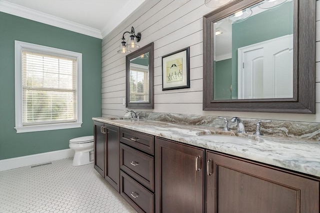 84 Bruce Rd, Concord, MA 01742 - bathroom featuring baseboards, ornamental molding, toilet, double vanity, and wooden walls