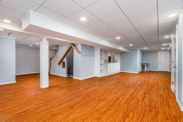 84 Bruce Rd, Concord, MA 01742 - basement featuring baseboards, stairway, light wood-type flooring, a drop ceiling, and recessed lighting