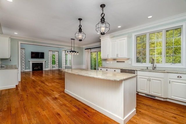 84 Bruce Rd, Concord, MA 01742 - kitchen featuring a sink, open floor plan, white cabinets, light stone countertops, and crown molding