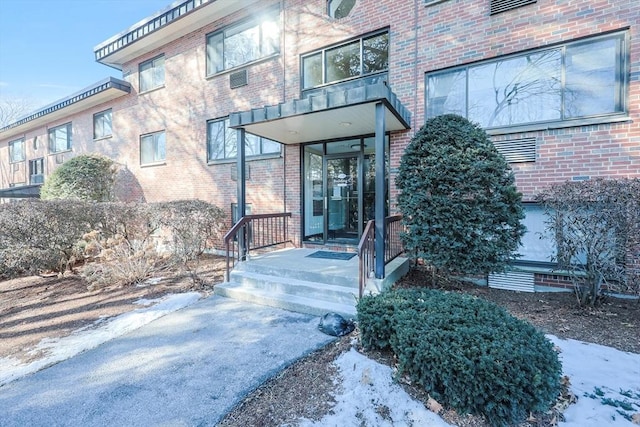 view of snow covered property entrance