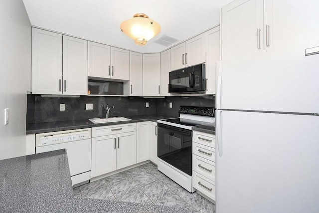 kitchen with tasteful backsplash, white cabinetry, sink, and white appliances