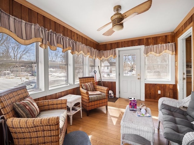 sunroom / solarium featuring a healthy amount of sunlight and ceiling fan