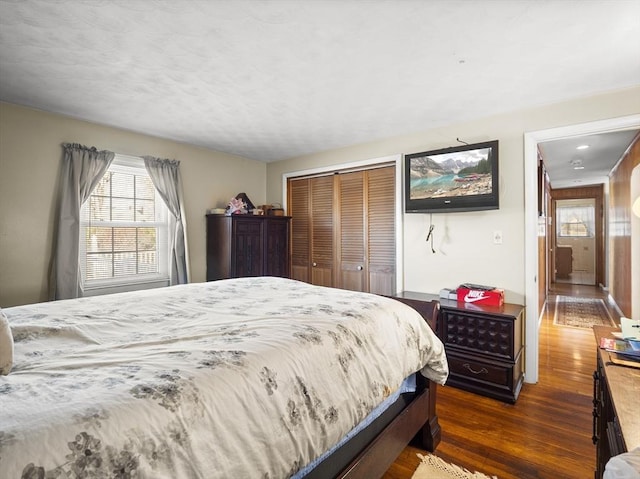 bedroom featuring dark wood-style floors and a closet