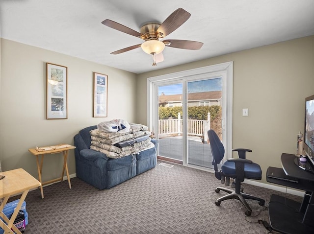 carpeted home office with a ceiling fan, visible vents, and baseboards